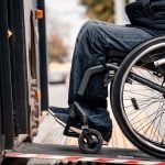 Person in a wheelchair enters vehicle with ramp upfit