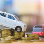 Miniature Vehicles on stacks of coins for fleet vehicle savings