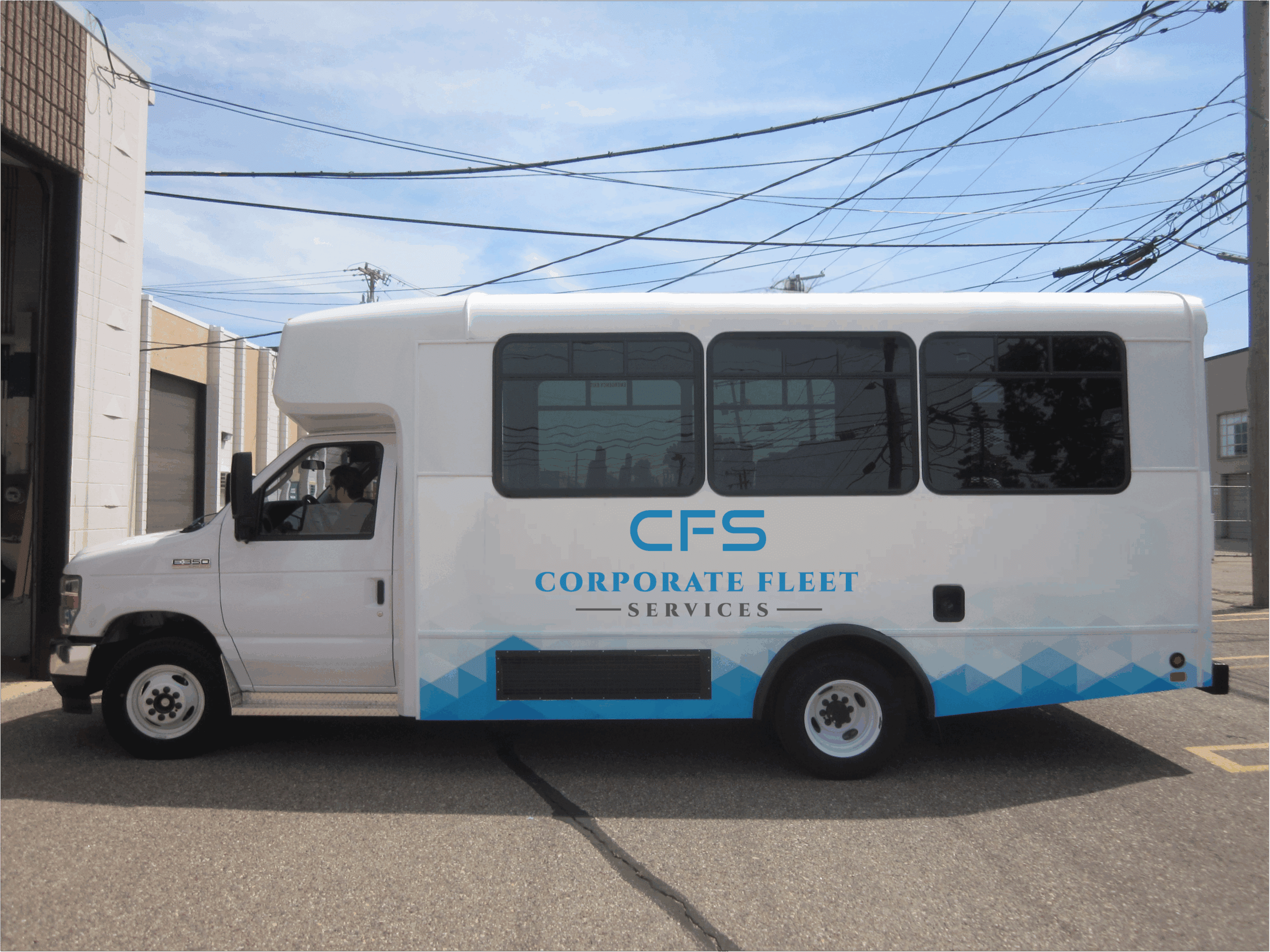 Upfitted shuttle with CFS Logo wrap in a parking lot