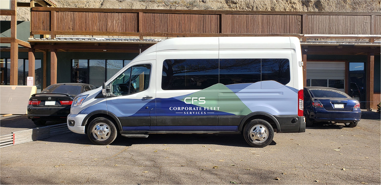 Upfitted CFS van with logo graphics wrap outside of a shopping complex