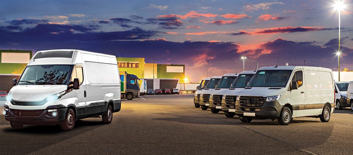 Commercial fleet vans in a parking lot at dusk