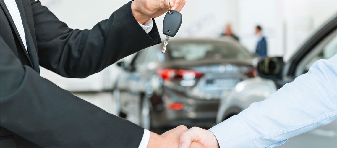 wo men shaking hands giving one the keys to a new leased company car