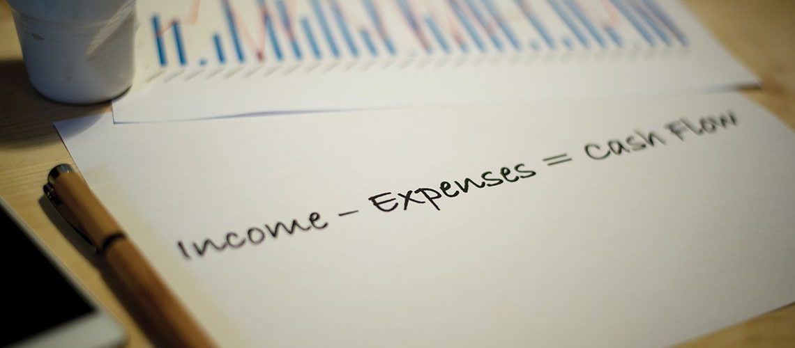 A piece of paper with the equation income-expenses = cashflow